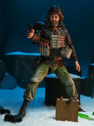 Action figure in winter gear holding a weapon in a snowy setting.