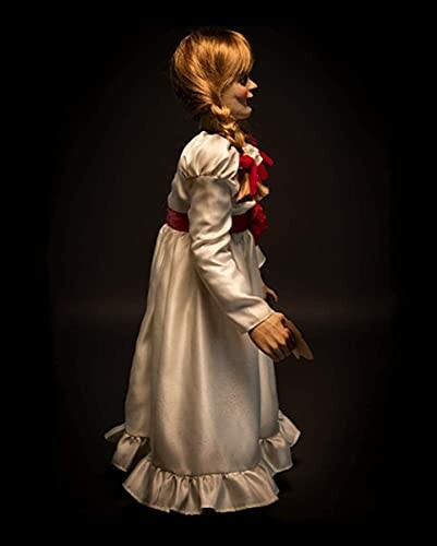 Creepy doll in white dress with side view