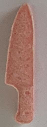 Pink knife-shaped object on a surface